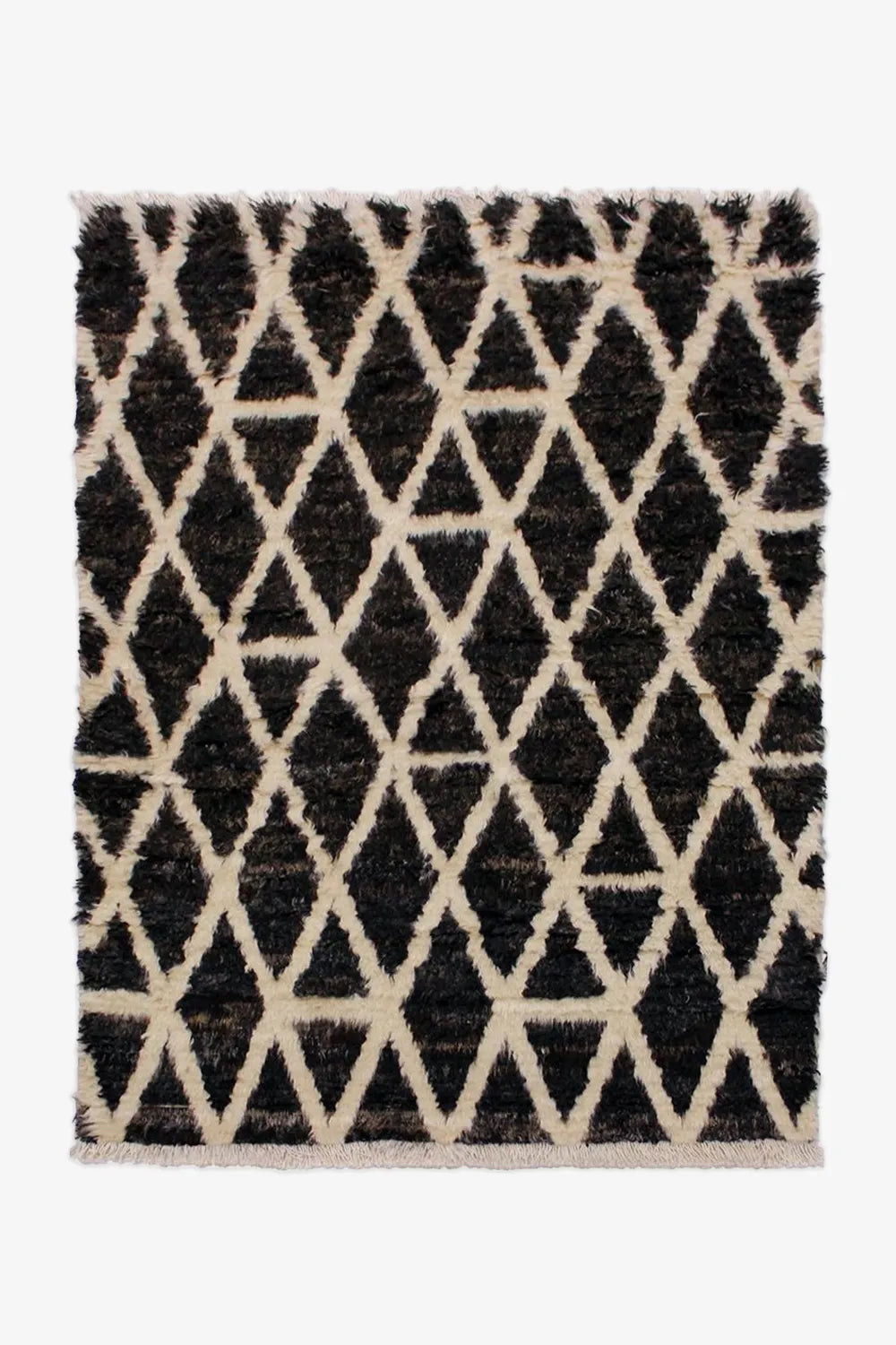 Black and cream Moroccan-inspired wool shag rug in 8x10 size, perfect for cozy living rooms and boho modern interiors