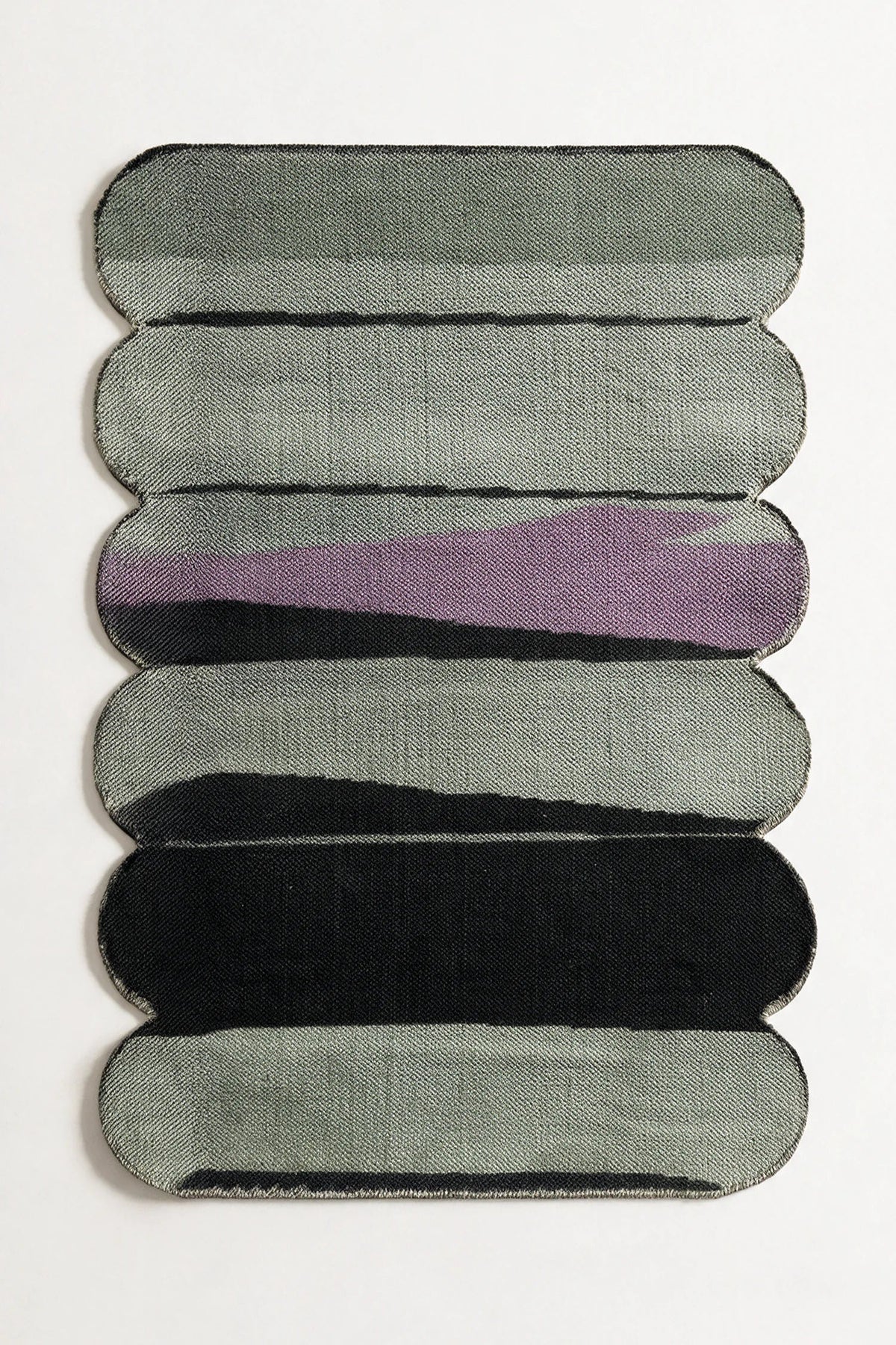 5x8 green and purple flatwoven rug with sculpted rounded edges and abstract curved stripe pattern