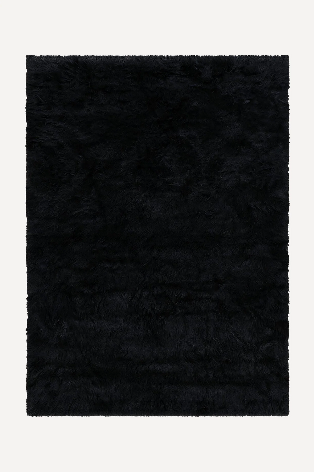 Black hand-knotted shag wool rug by JUBI, shown flat from above