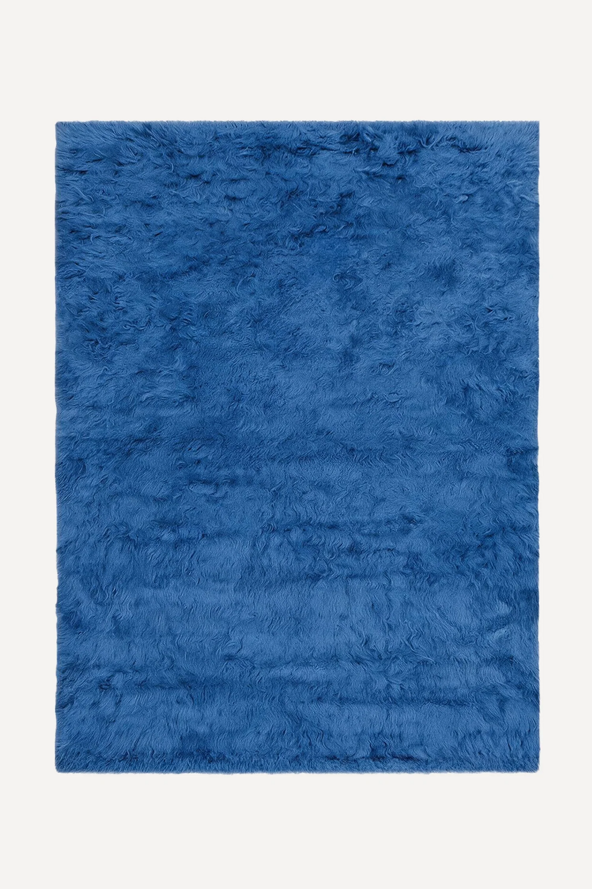 Blue hand-knotted shag wool rug by JUBI, shown flat from above