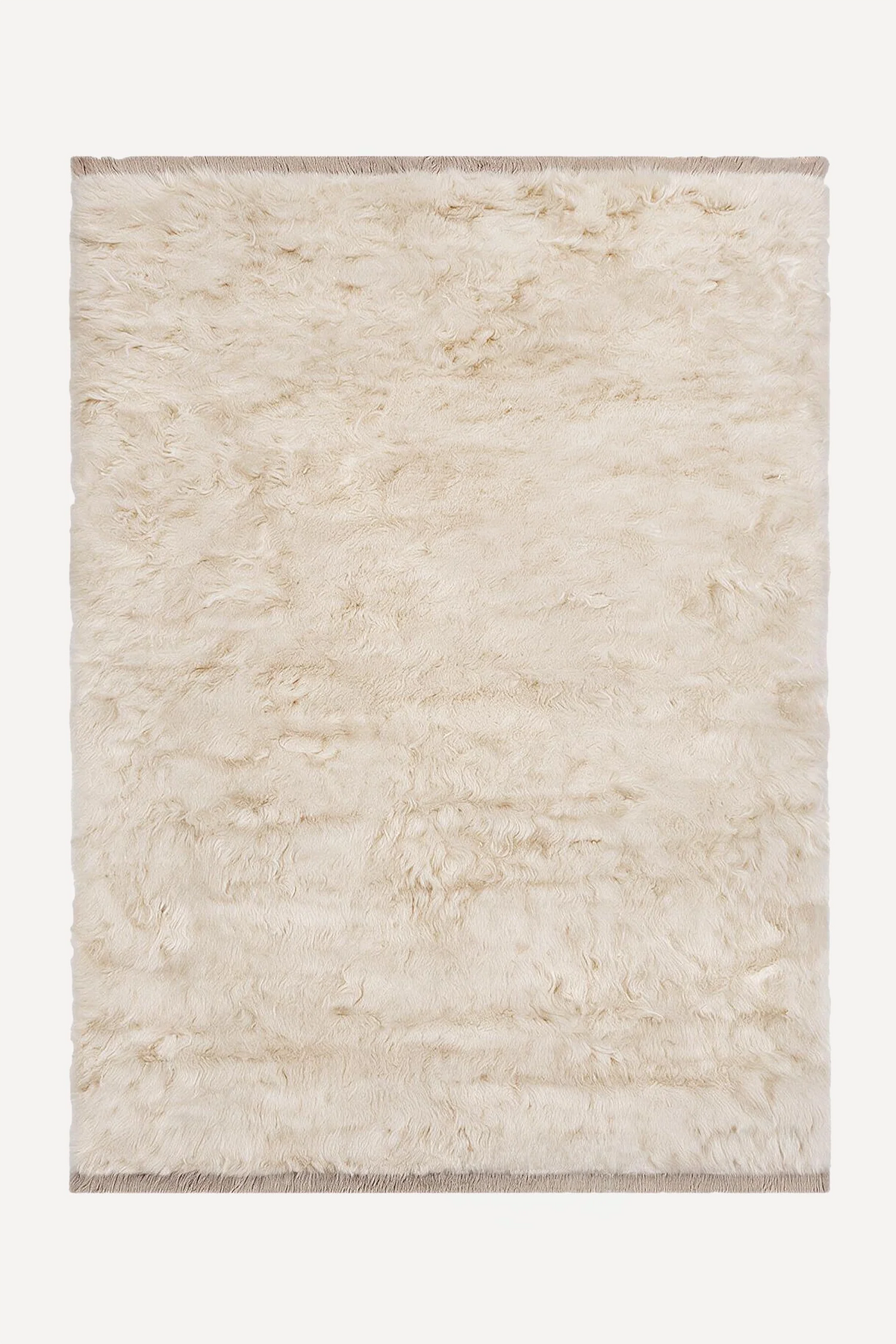 Cream hand-knotted shag wool rug by JUBI, shown flat from above