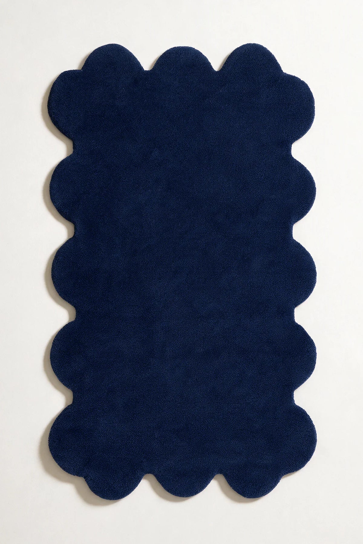 8x10 navy blue scalloped wool rug with sculpted hand-tufted pile, ideal for modern or coastal interiors
