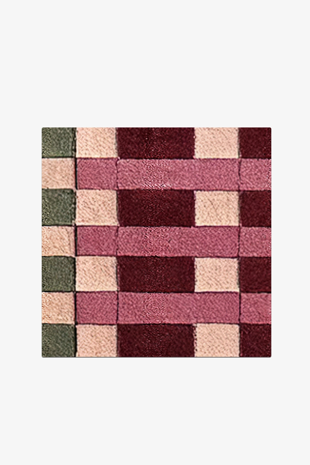Square patchwork rug with a geometric pattern on a white background
