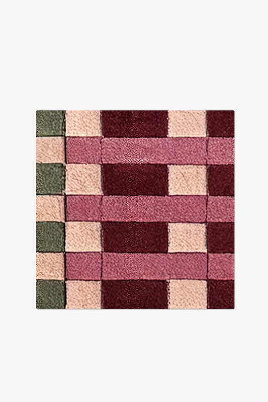 Square patchwork rug with a geometric pattern on a white background