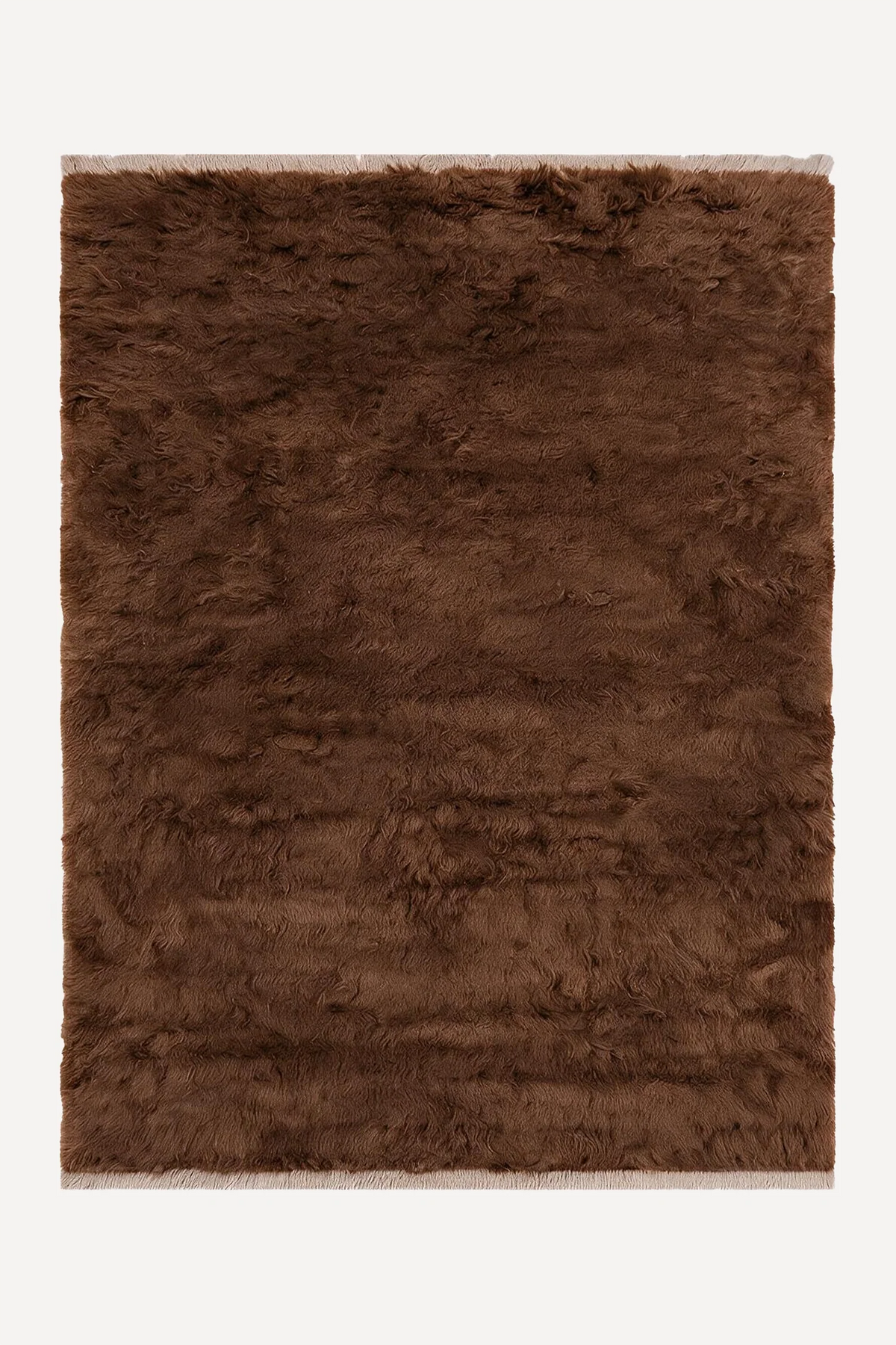 Umber hand-knotted shag wool rug by JUBI, shown flat from above